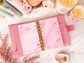Pink Dreamy Ribbon cash tracker insert with satin bow details, a marble-inspired background, and pre-punched holes for an A6 budget binder.