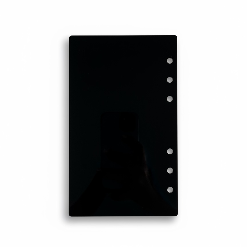 Black planner cover with ring binding on a white background